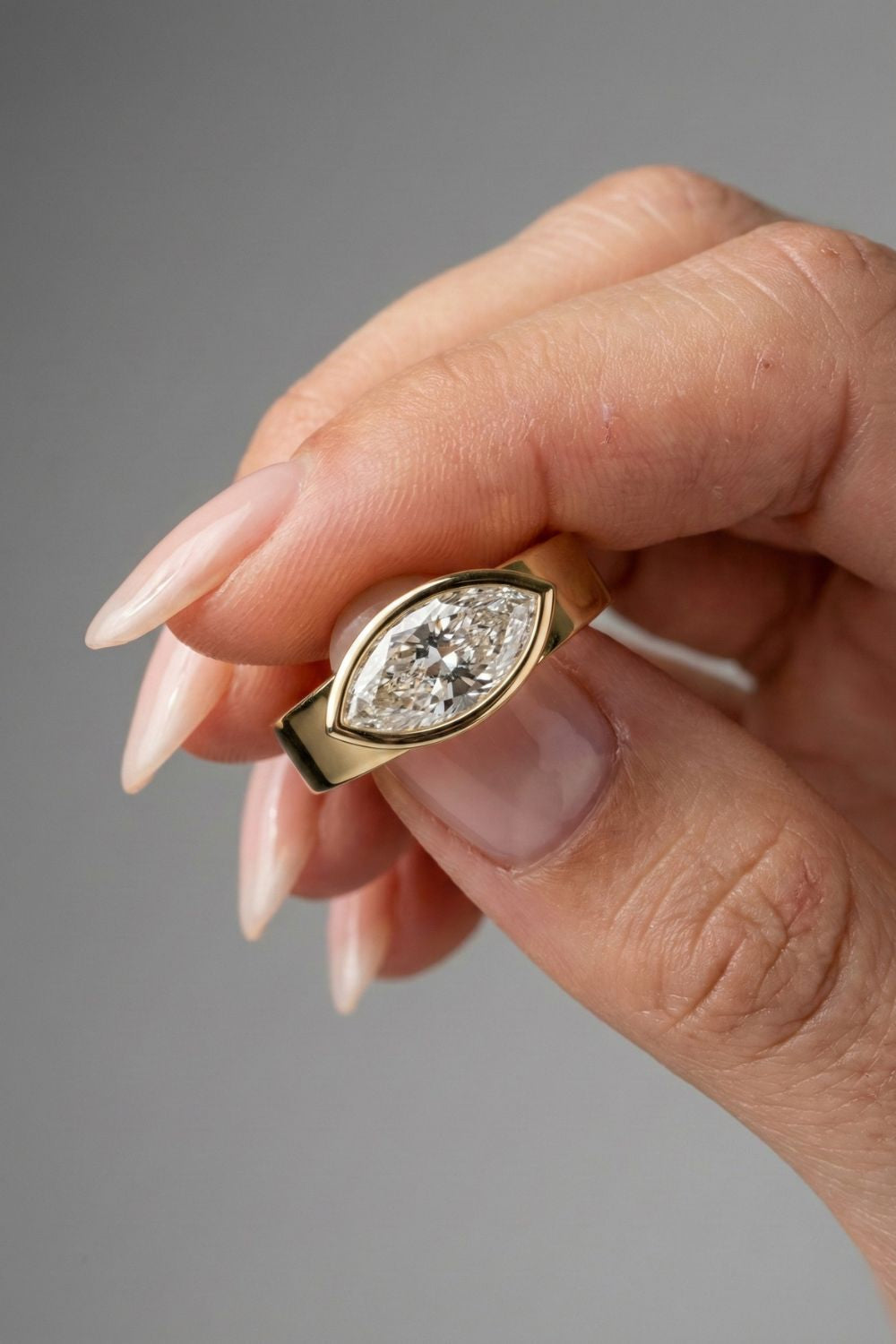 East-West Marquise Cut Bezel Solitaire Moissanite Engagement Ring